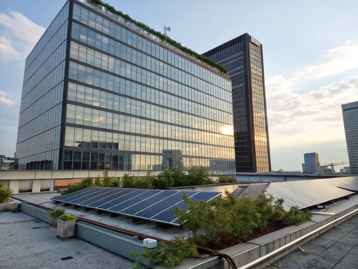 A modern office building with glass facade, showcasing advanced BMS technology with visible sensors and control panels, emphasizing energy efficiency and smart building management.